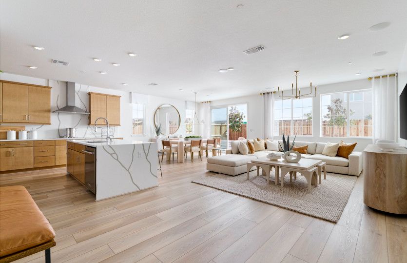 Open gathering area with view of kitchen
