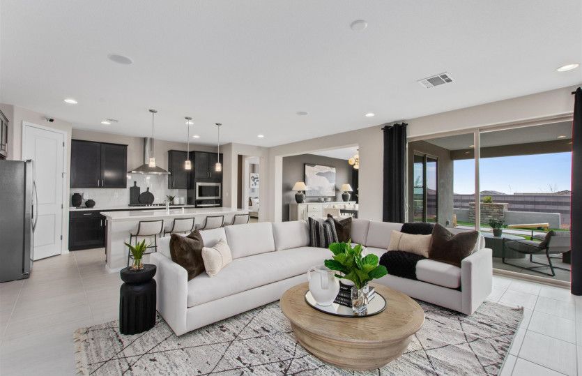 The gathering room opens to the kitchen and café, as well as the covered patio and backyard for indo