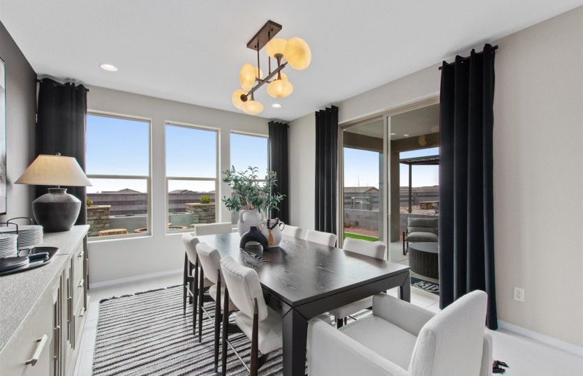 The well-lit cafe features a tray ceiling with decorative accents and access to the backyard and cov