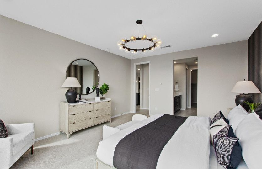 Your owner's suite oasis - a cozy room with an accent wall and a decorative lighting fixture.