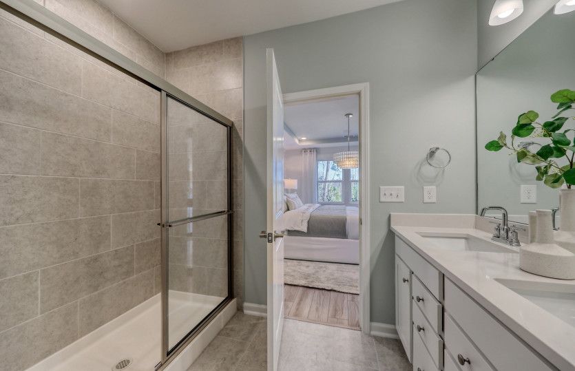 Owner's Bath with luxurious framed walk-in shower and dual-sink vanity.