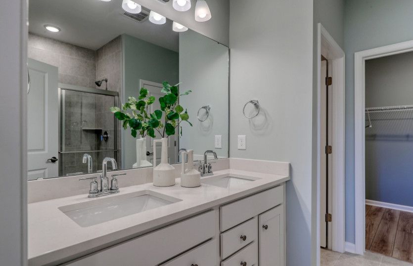 Secondary bathroom with a dual vanity.