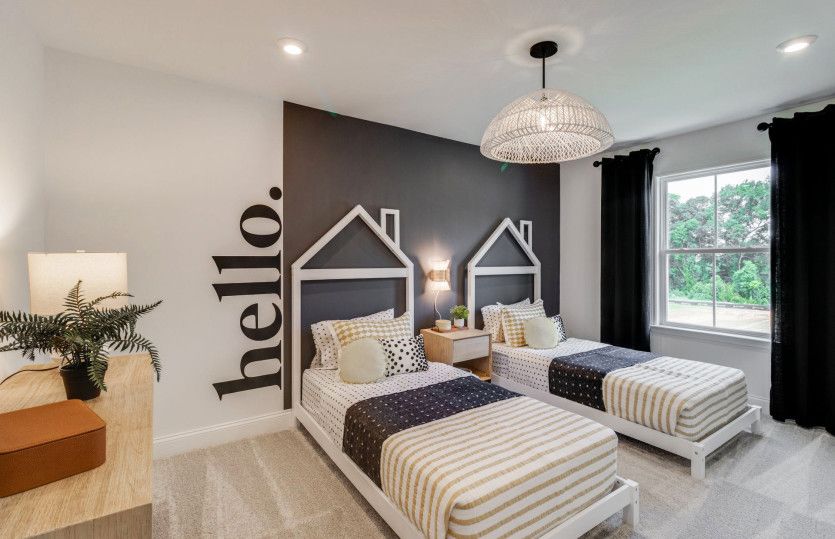 Serene window-filled secondary bedroom perfect for a growing household.