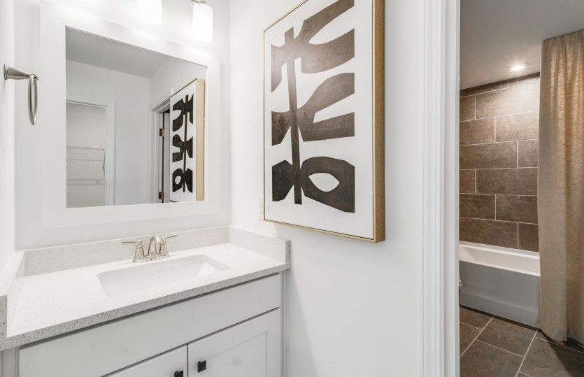 Bright secondary bathroom with modern tile.