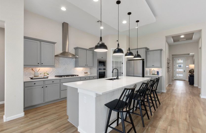 Award-winning Parklane home design is popular for the open gathering room, kitchen, café, and patio