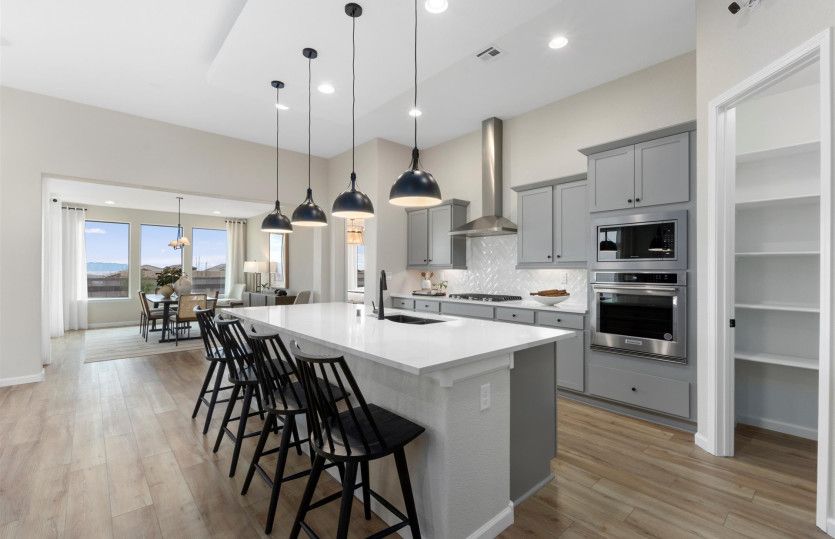 Staggered cabinets, designer pendant lights, and built-in stainless-steel appliances show off the Pa