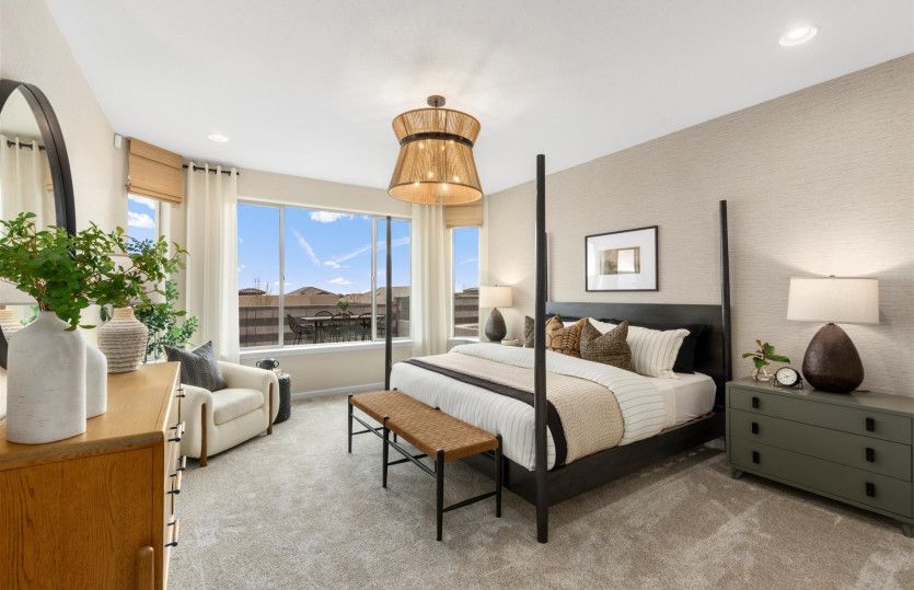 Large windows and accent lighting fixtures amplify the spacious owner's suite.