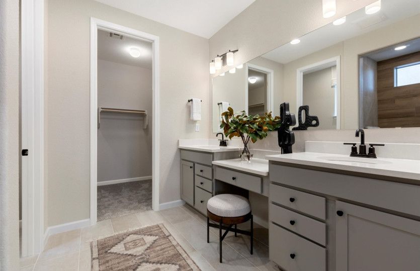 Dual vanity boasts a large mirror and ample cabinet space.