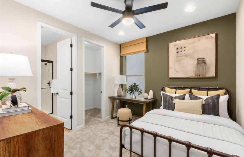 Third bedroom with painted accent wall and its own attached bathroom.