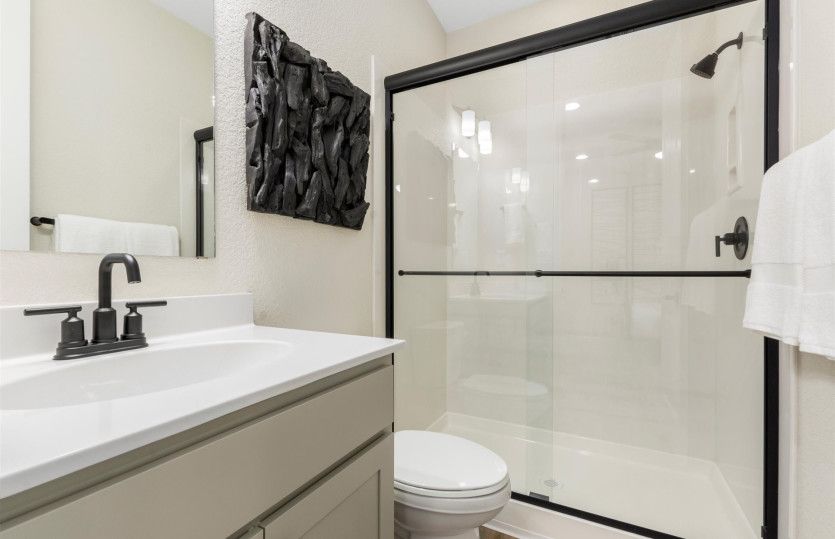 Attached bed/bath shown here with a large vanity and walk-in shower.