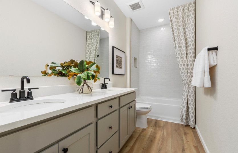 Secondary bath shown here with a large vanity and walk-in shower.