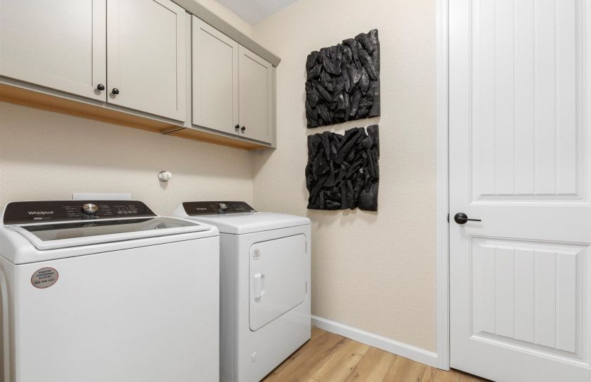 The laundry room boasts additional storage space.