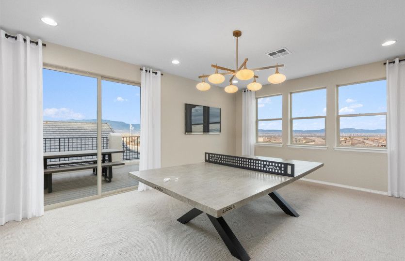 Upstairs game room with attached balcony.
