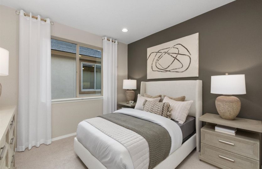 Secondary bedroom upstairs features cozy carpeting, two-tone paint detail and a walk-in closet.