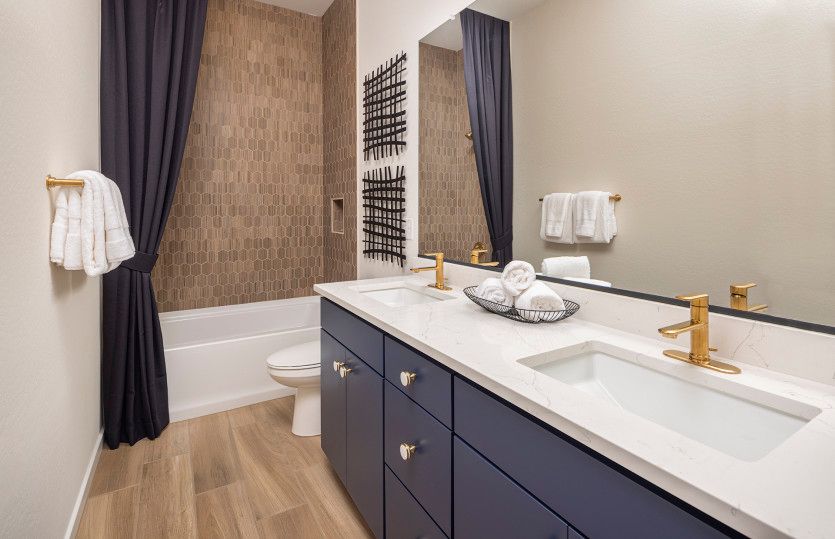 Secondary bathroom with a tile shower and tub, plus dual sinks.