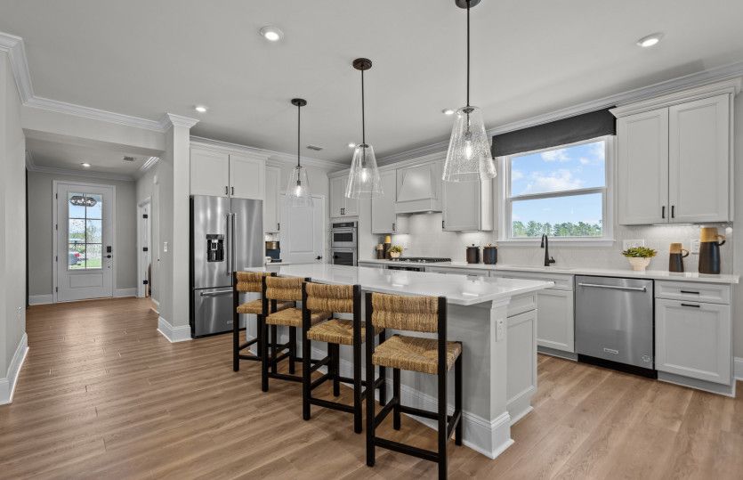 Kitchen island off gathering room to seat additional four guests.