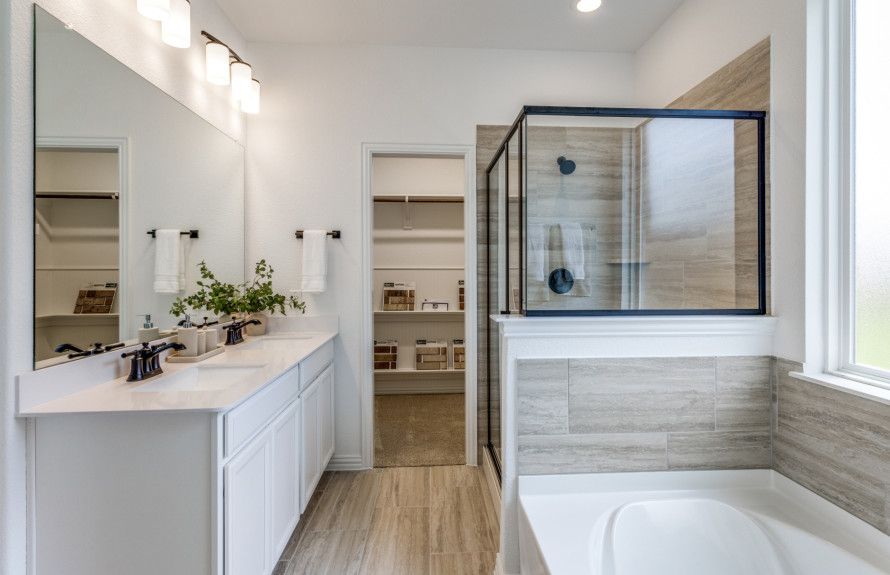 Luxury owner's bath with shower, tub, and double vanity