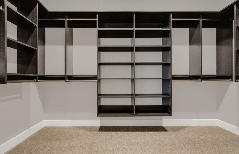 Spacious walk-in closet provides plenty of storage space for all your clothes, shoes, and accessorie