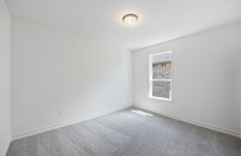 Spacious secondary bedroom with ample closet space*model representation