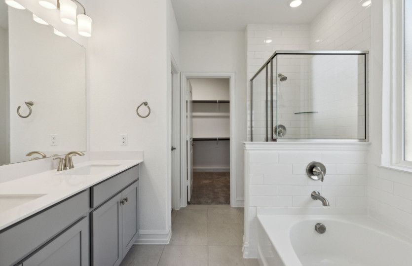 Spacious owner's bathroom with dual vanity and oversized shower