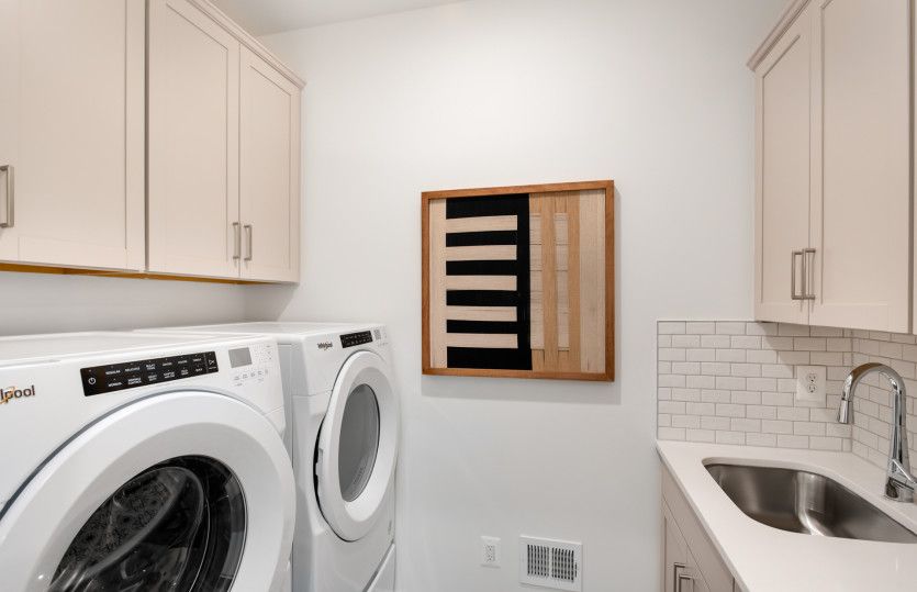 Super Laundry with a Utility Sink & Cabinetry for Extra Storage