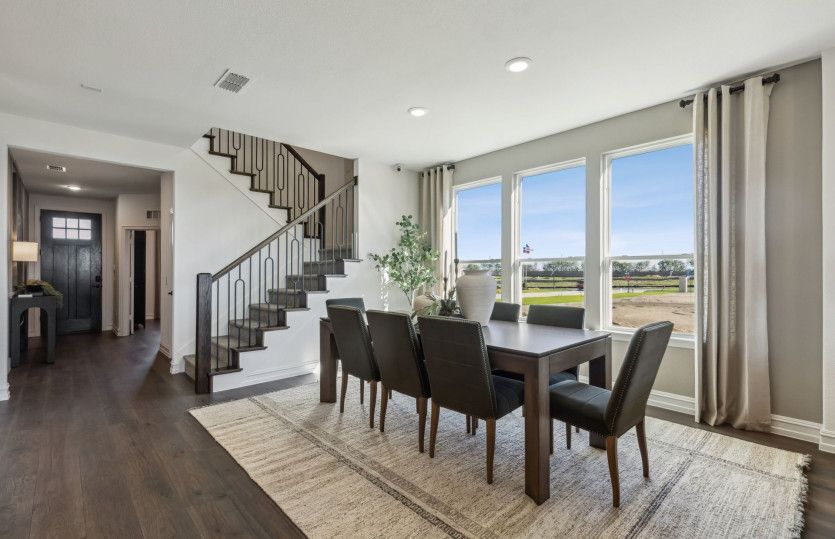 Dining area with view of kitchen and gathering room*model representation