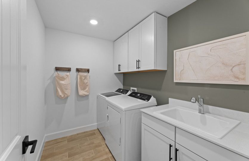 Laundry room with sink and cabinets for extra storage space