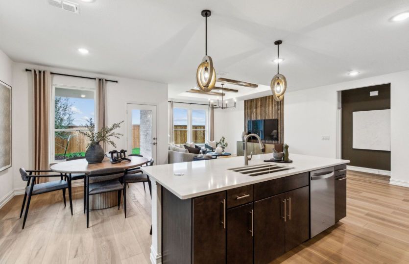 Large kitchen island overlooking main living areas *model representation