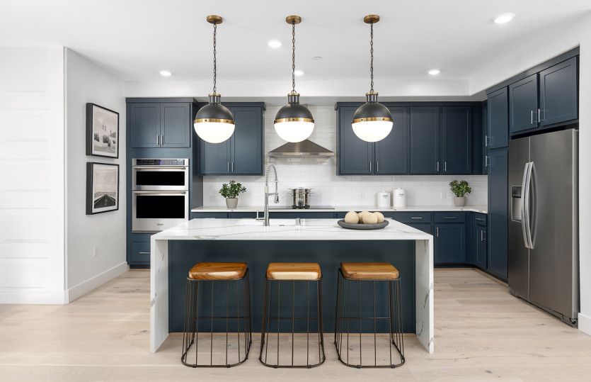Kitchen with waterfall edge island countertops