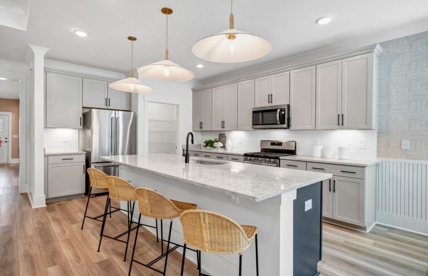 Beautiful open kitchen with bright, warm lighting and a large island.