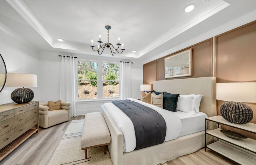 A king-size bed is the focal point, accompanied by elegant furniture that balances functionality wit