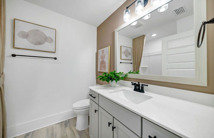 Featuring sleek fixtures and a minimalist design, this bathroom offers both style and practicality
