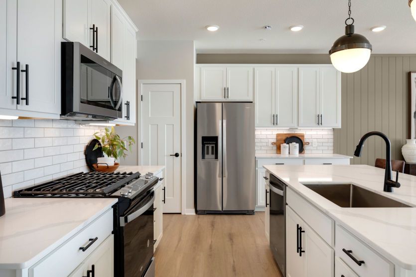 Bright White Kitchen with Warm, Complementary Flooring
