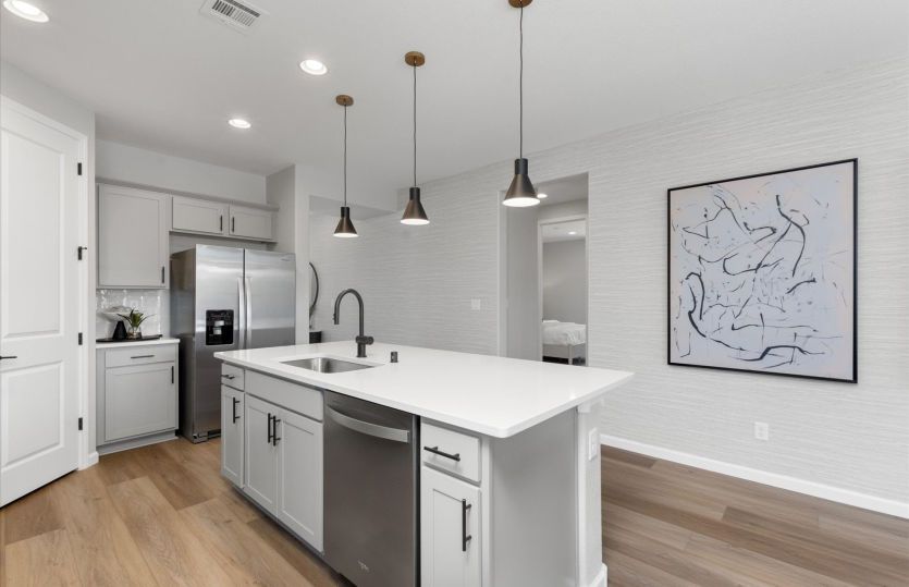 Kitchen island with stainless steel appliances and optional pendant lighting.