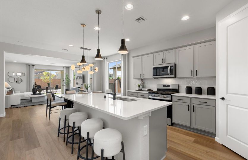 A perfect kitchen fit for a chef comes complete with stainless steel appliances and a roomy island f