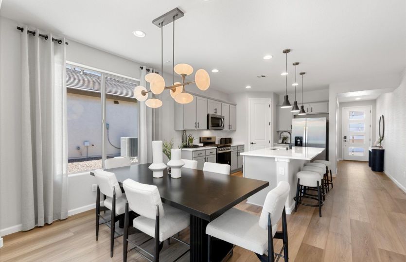 Cafe located between the kitchen and gathering space comfortably seats six guests or family members.
