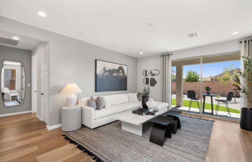 Bright and open gathering room with a sliding glass door to the large covered patio.