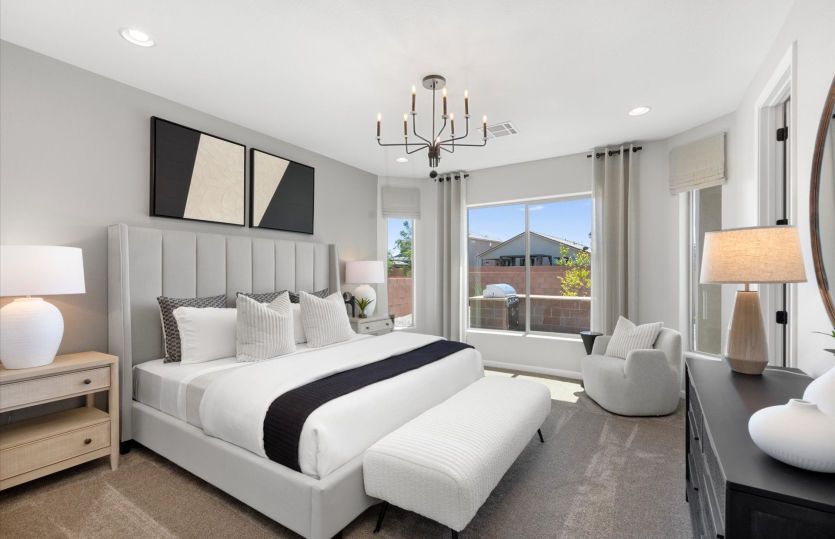 Owner's Suite in the Hewitt home design shown with a decorative lighting fixture and neutral paint.