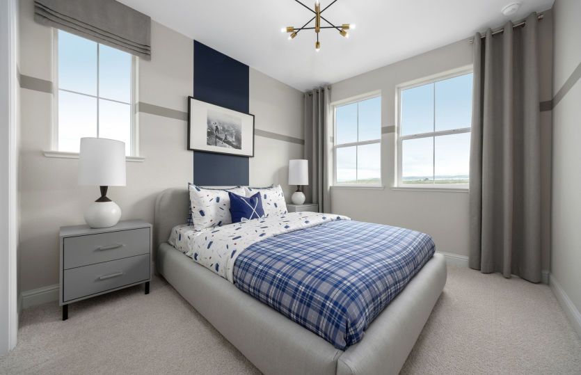 Modern secondary bedroom with large windows