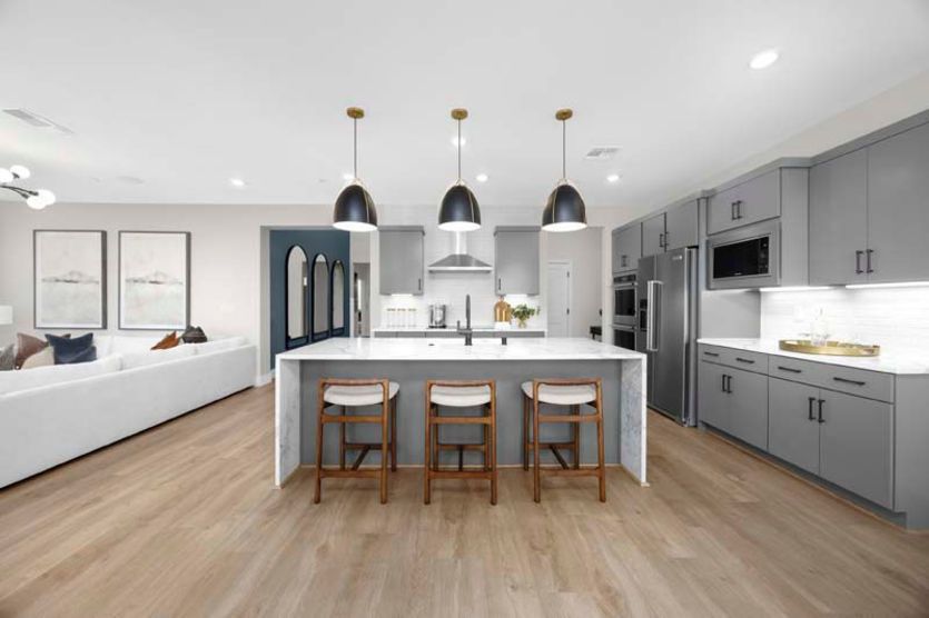 Kitchen with waterfall edge island and eat-in bar top