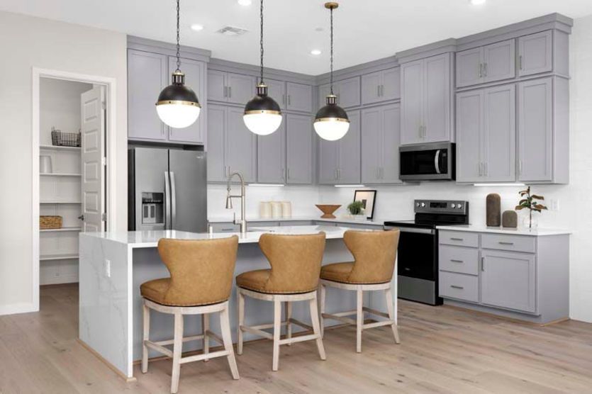 Kitchen with waterfall edge island and ample cabinet space