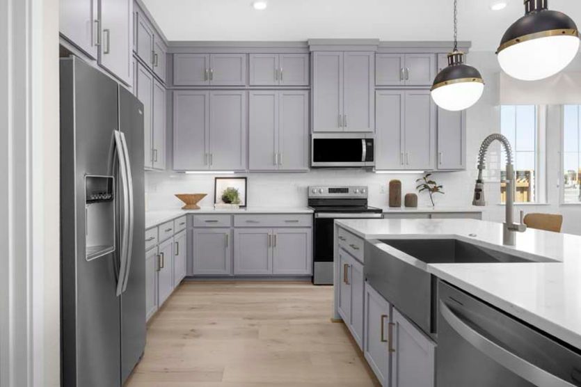 Gorgeous kitchen with stacked cabinets and decorative lighting