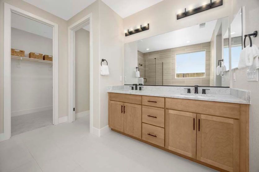 Owner's suite bath with double vanity and walk-in shower