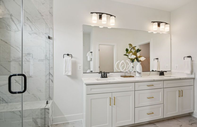 Double Sinks and an Oversized Walk-in Shower in the Owner's Bath
