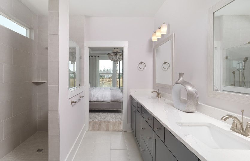 Spacious Owner's Suite bath with walk-in tile shower and dual vanity.