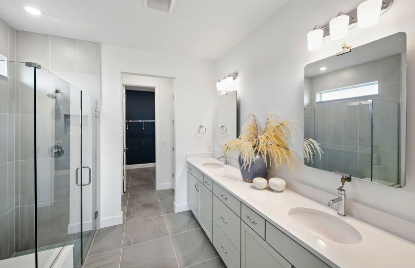 The Owner's bathroom with double vanity and walk-in shower