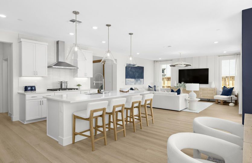 Open gathering area with view of kitchen