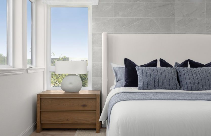 Owner's suite with tile headboard wall