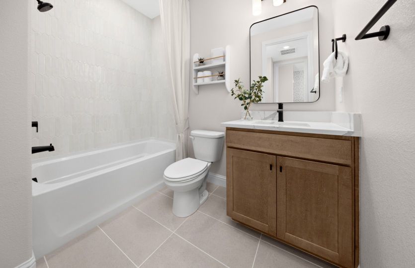 Bathroom 2 with tub shower and freestanding mirror