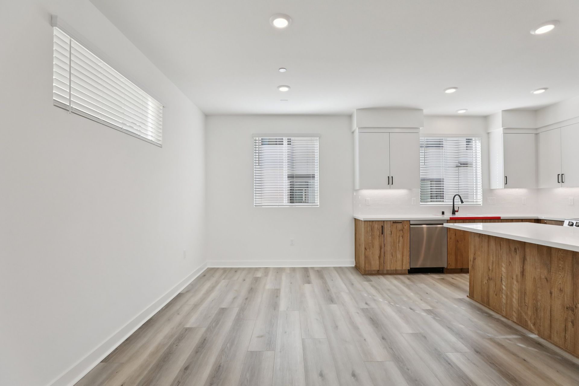 Dining area with upgraded flooring and natural light